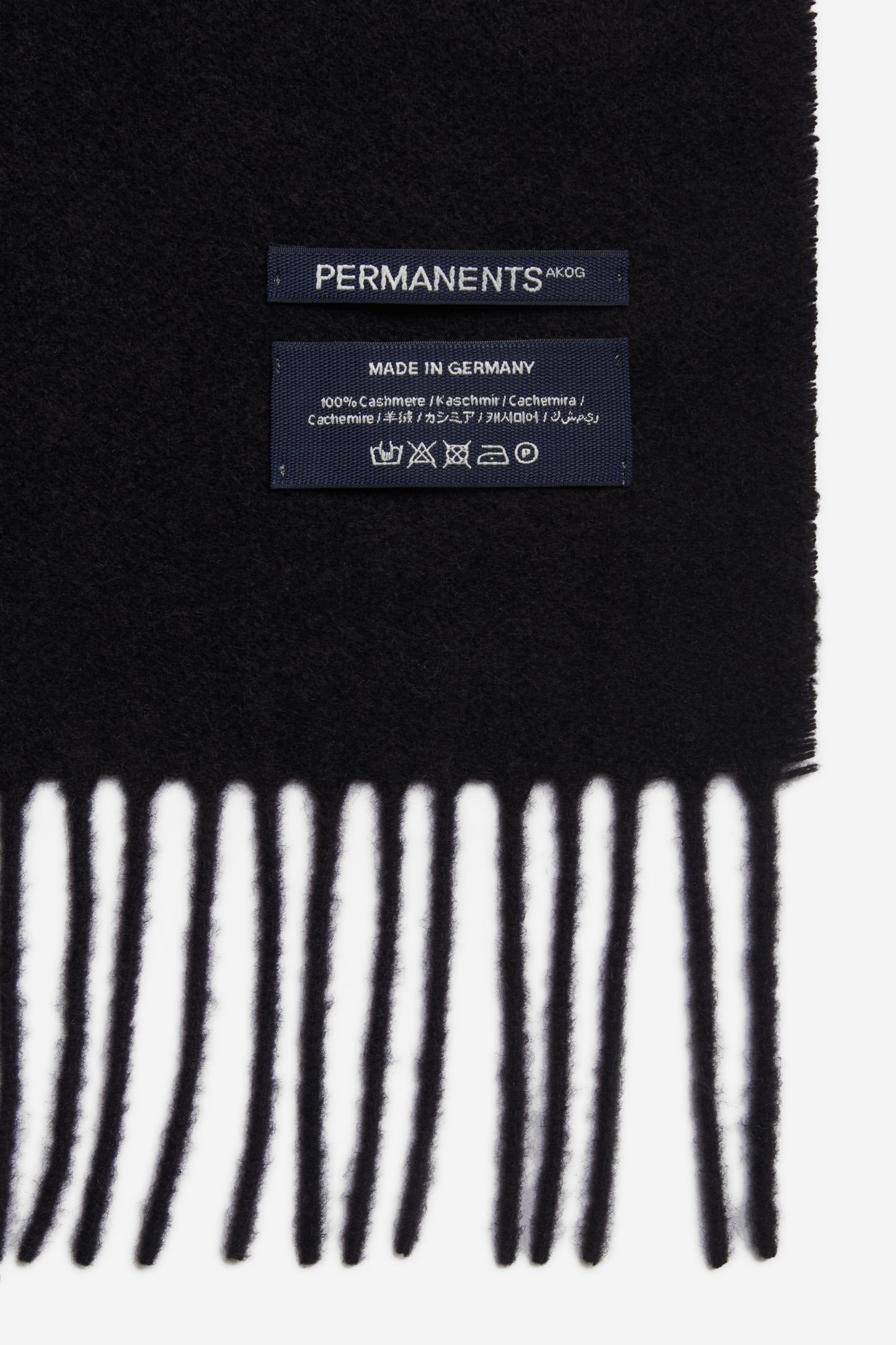 Unisex accessories scarf, 100% cashmere, black, with fringe and "PERMANENTS" label.