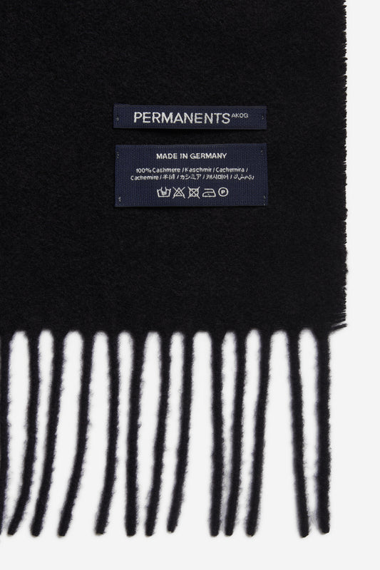 Unisex accessories scarf, 100% cashmere, black, with fringe and "PERMANENTS" label.