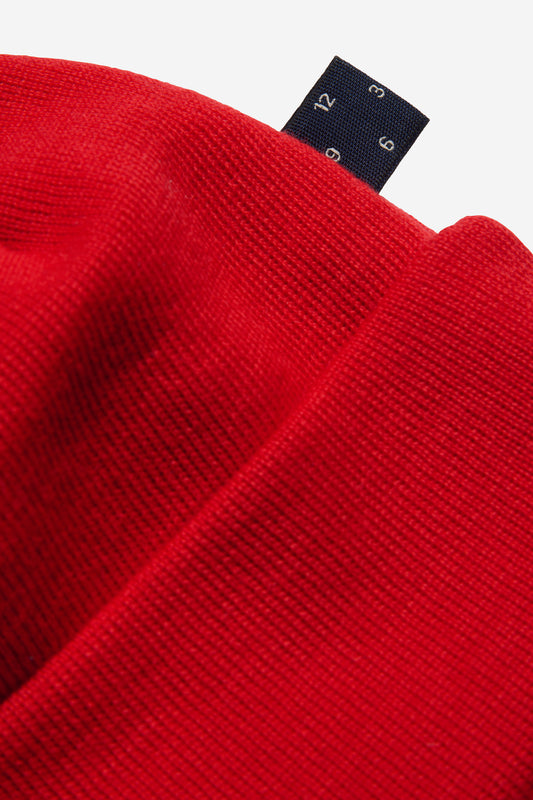 Unisex accessories beanie, 100% merino wool, red, with a dark blue brand tag.