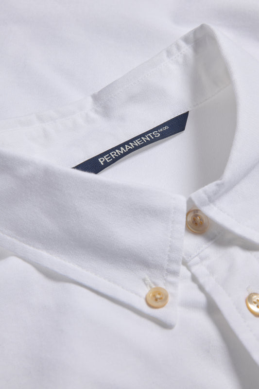 Men's/Women's long-sleeved shirt, organic cotton, white, with pearl buttons and collar detail.