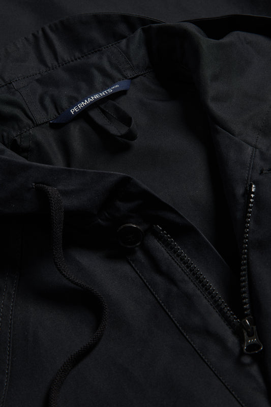 Men's outerwear parka, black organic cotton EtaProof® fabric, with adjustable hood, zipper, and button closure.