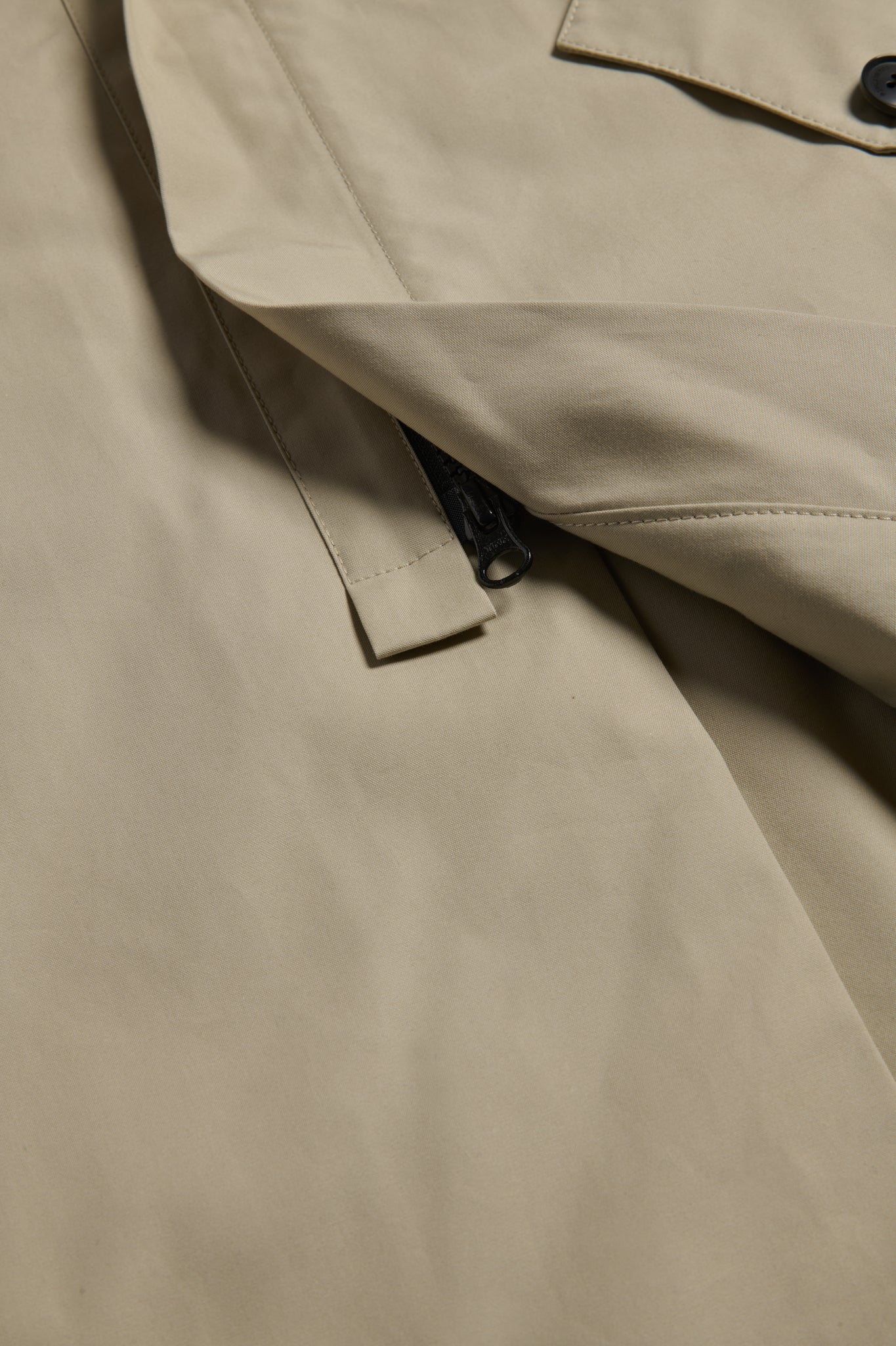 Unisex outerwear parka, organic Swiss EtaProof® cotton, stone, with flap pockets and zipper detail.