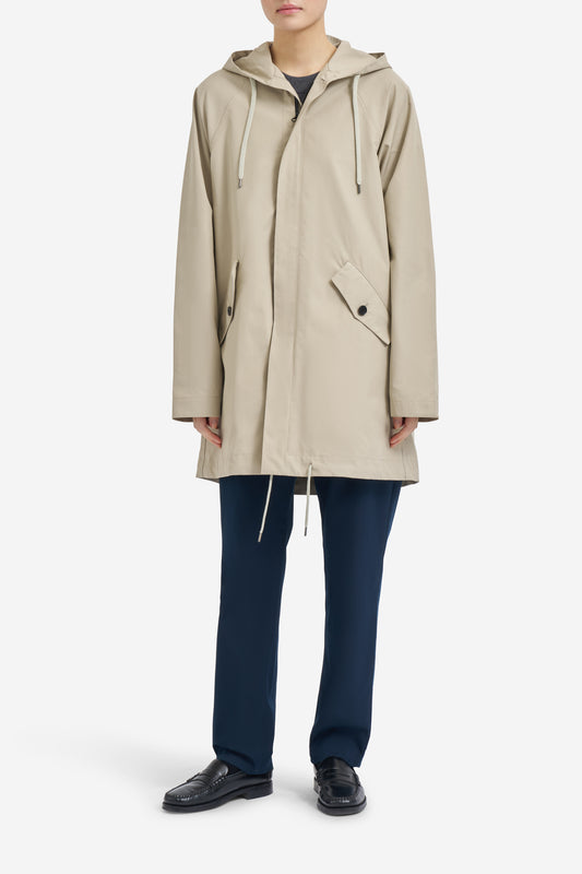 Women's outerwear parka, organic cotton, stone, with adjustable hood, hem, and flap pockets.