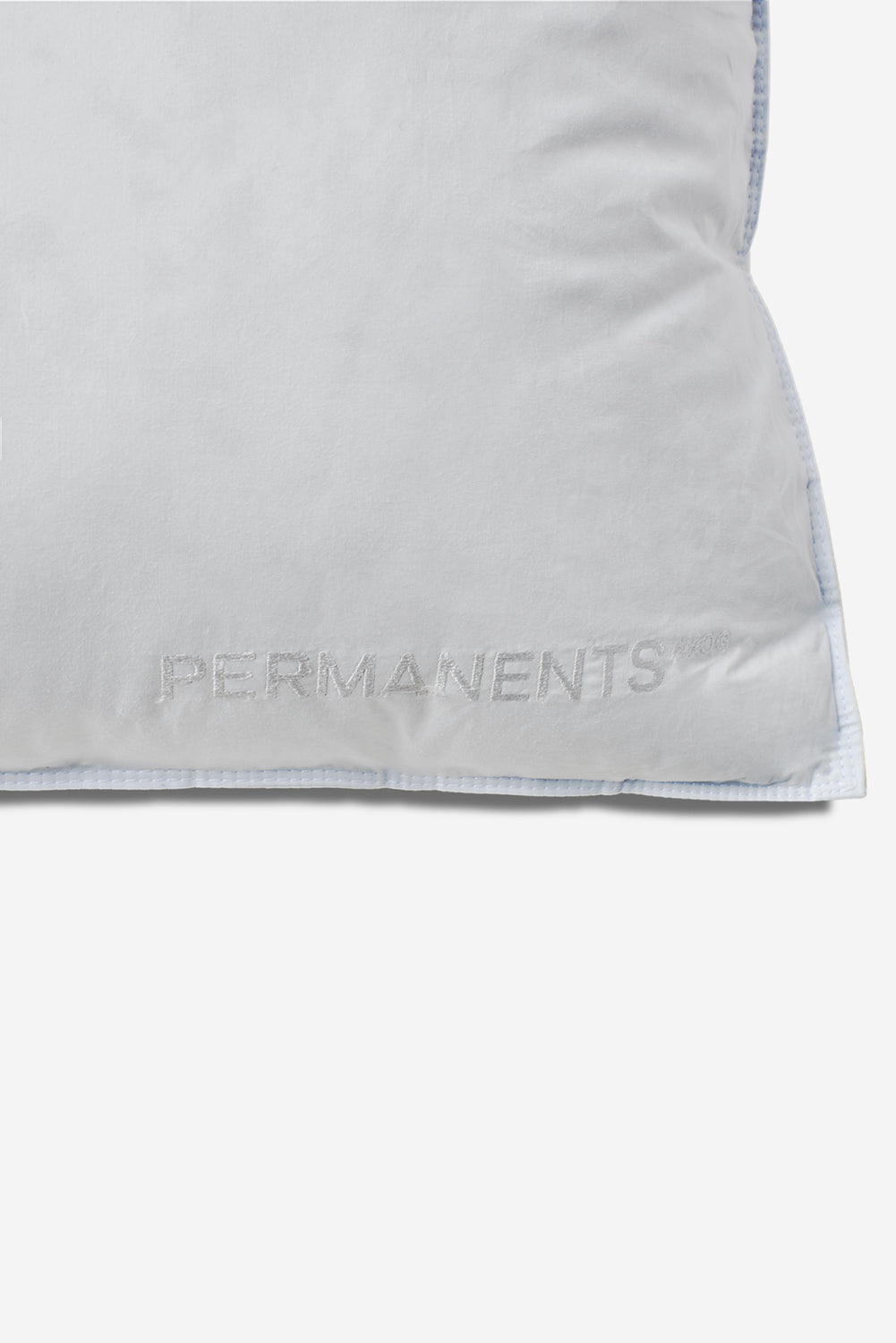 White Eiderdown Pillow with embroidered "PERMANENTS" logo and light blue piped edges.