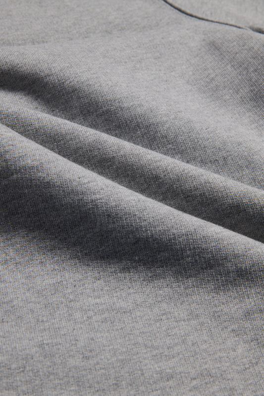Unisex long-pants, heavy jersey organic cotton, grey melange, with subtle fabric folds.