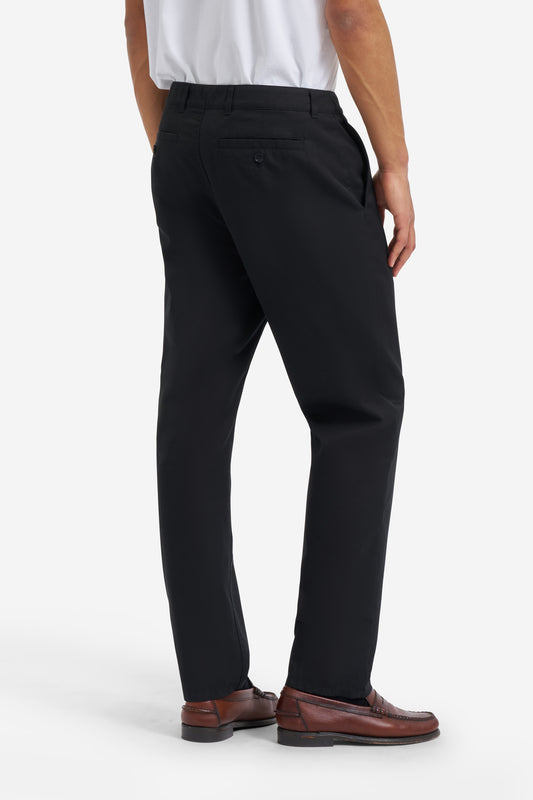 Men's long-pants, organic cotton twill, washed black, with button-up box back pockets.