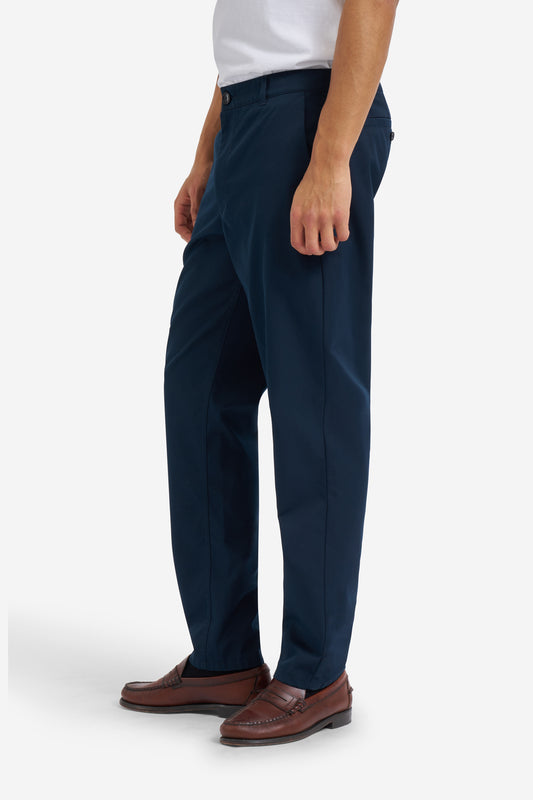 Men's long pants, organic cotton twill, washed navy, with side pockets and button-up back pockets.