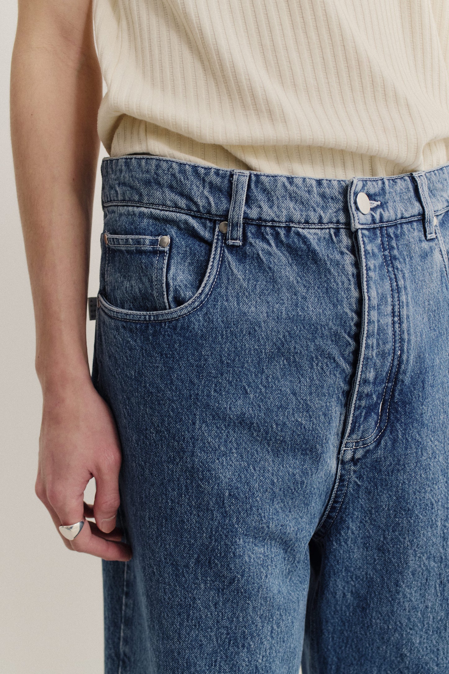 Men's long-pants, cotton mix denim, stone washed mid-blue, with a loose fit and tapered leg.