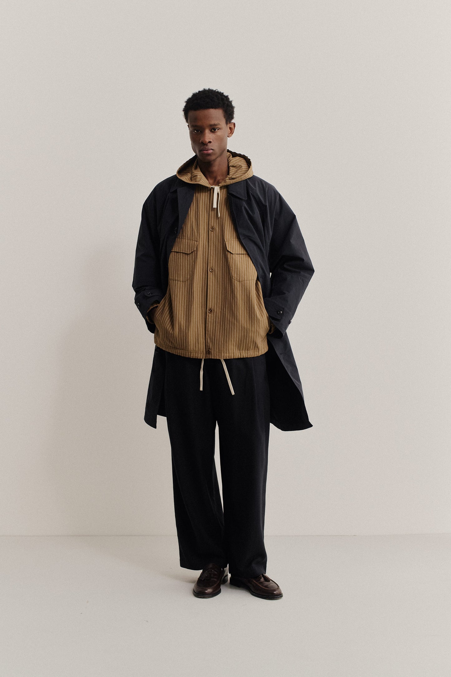 Men's outerwear jacket, cotton-linen seersucker, pinstriped brown Tsavo Jacket over a navy mac.