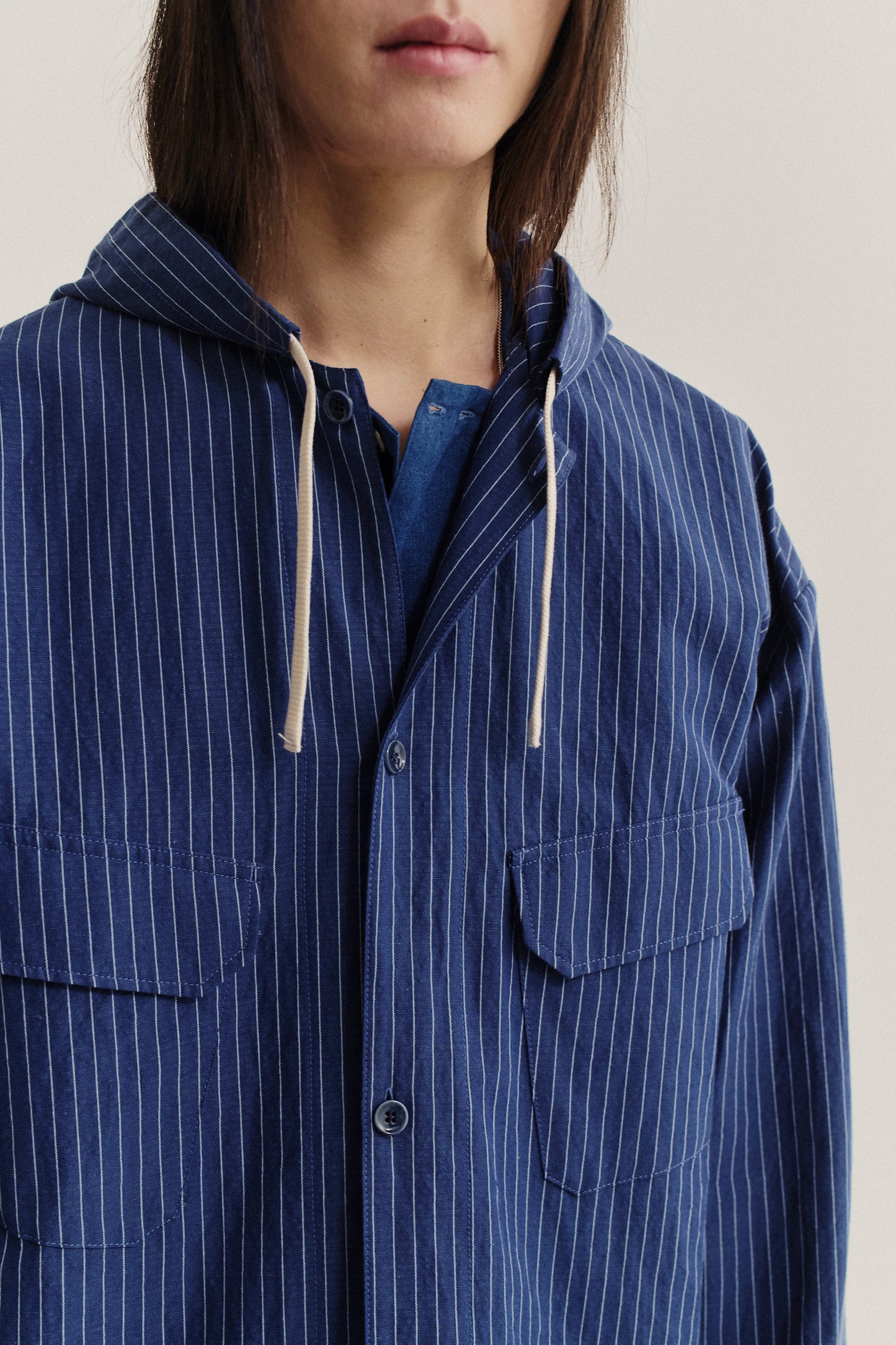 Men's outerwear jacket, cotton-linen seersucker, navy with white pinstripes, hooded, chest pockets.