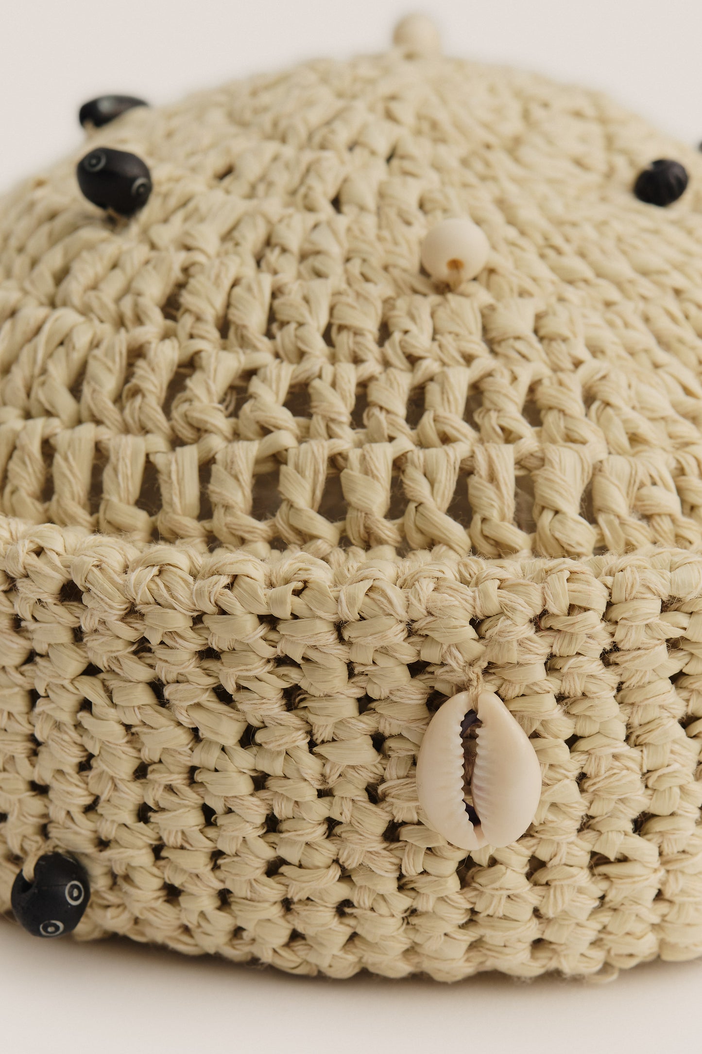Women's accessories, crochet cap, raffia-like viscose-linen-cotton blend, natural beige with mussels and black wooden beads.