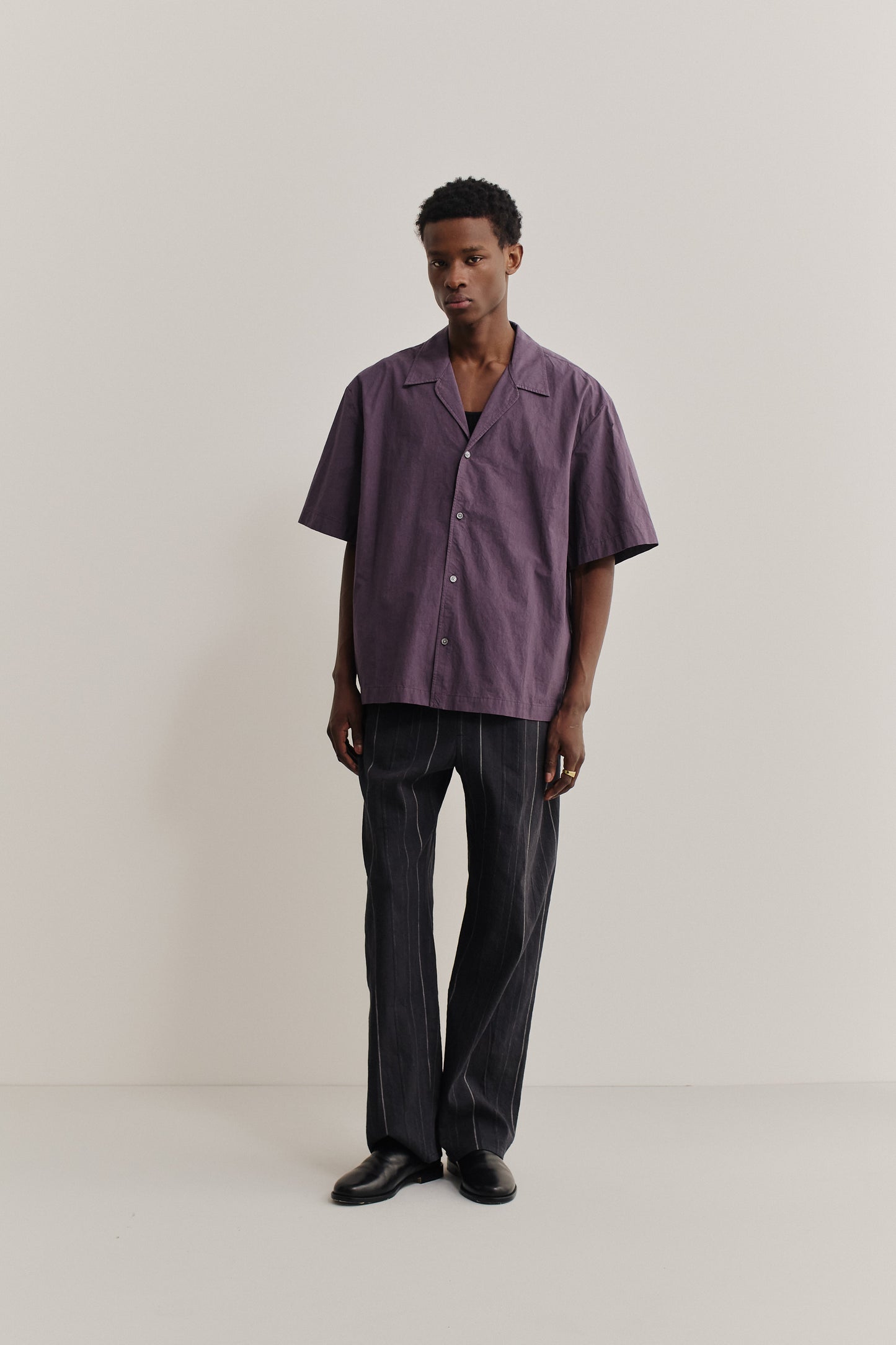 Men's short-sleeved shirt, cotton, subtly grainy, purple, relaxed fit, notched collar.