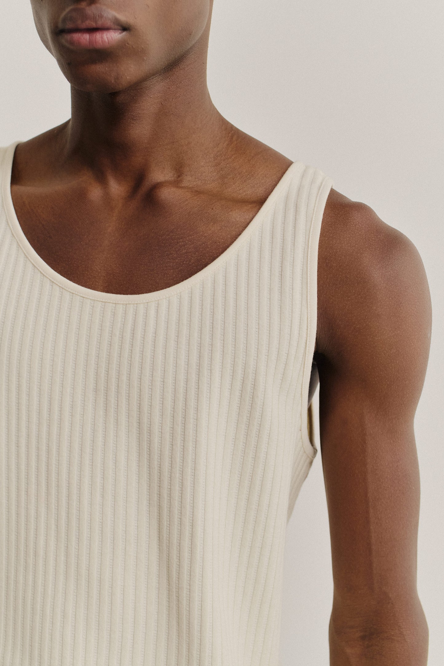 Unisex jersey tanktop, off-white cotton rib with pointelle detailing, wide scooped neckline.
