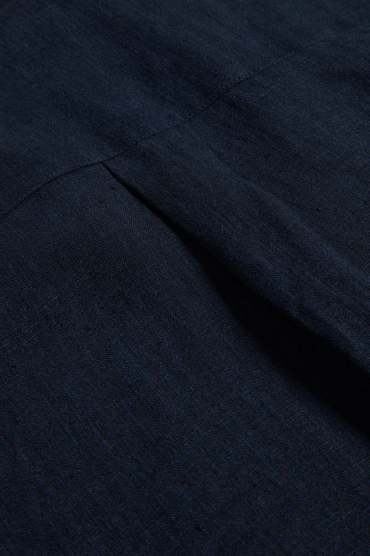 Unisex pyjama set, 100% Belgian linen, midnight navy, with subtle piped trim detail.
