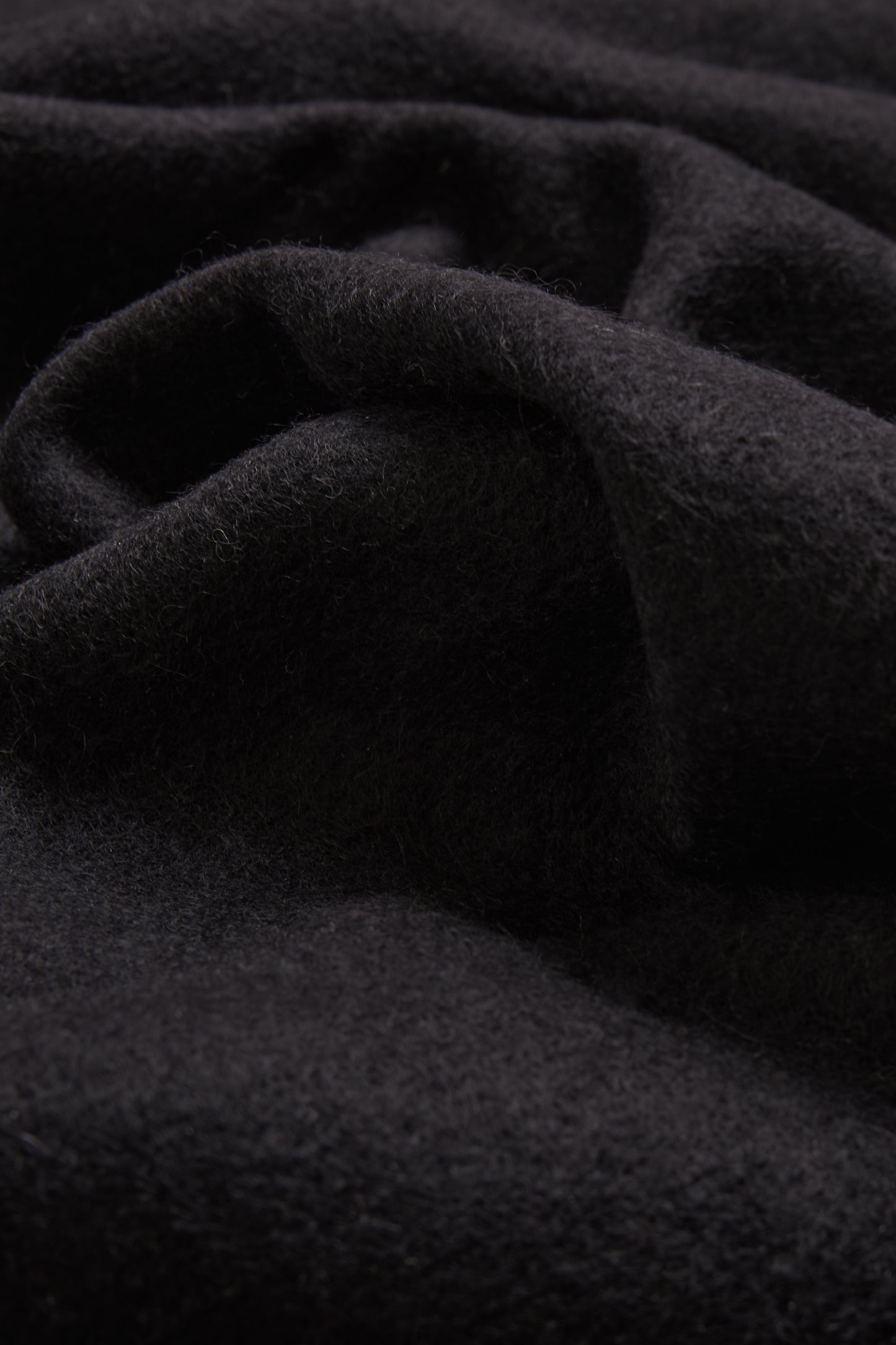 Women's accessories cashmere scarf, black, soft pure cashmere fabric with subtle folds.