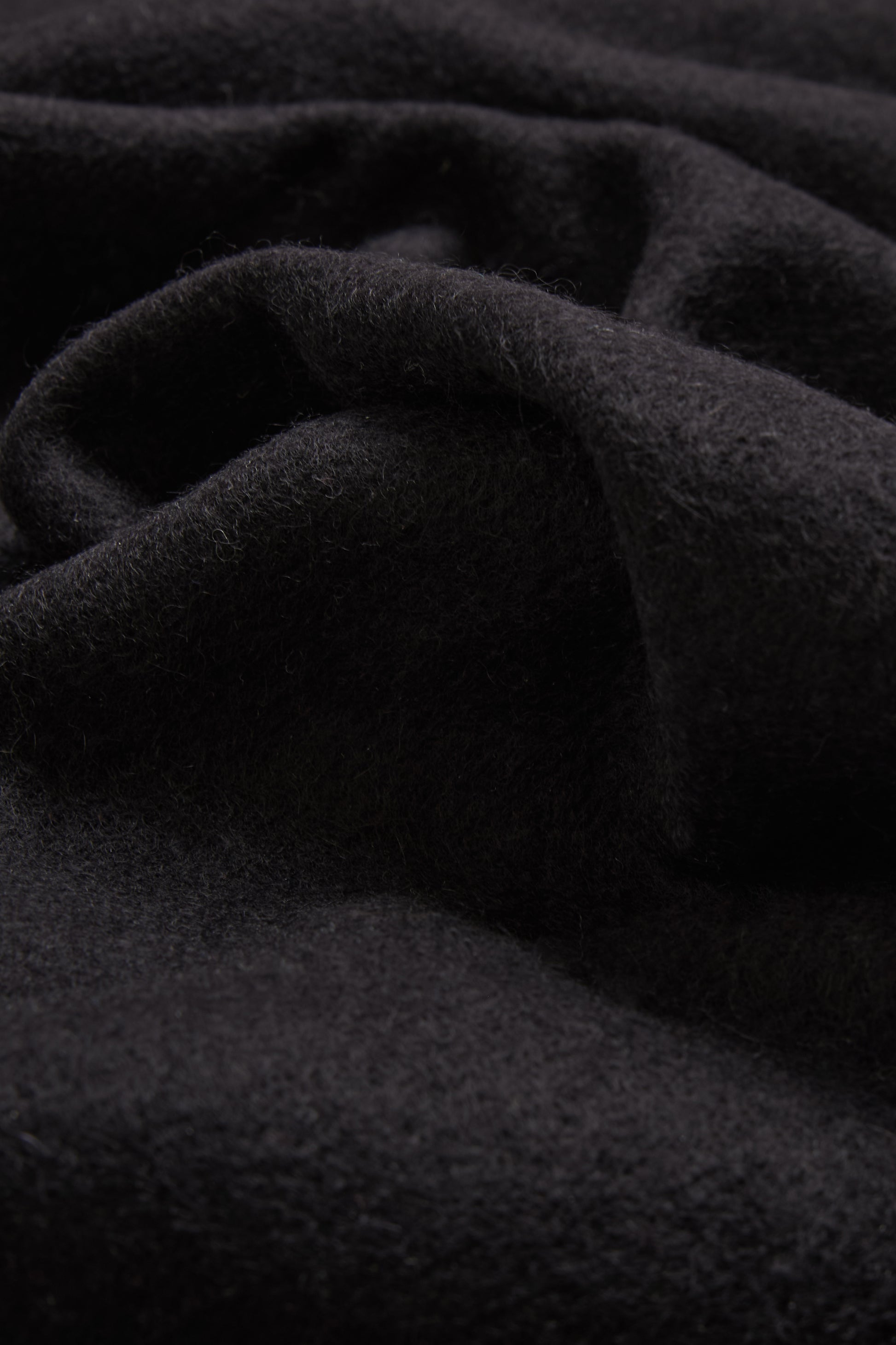 Women's accessories cashmere scarf, black, soft pure cashmere fabric with subtle folds.