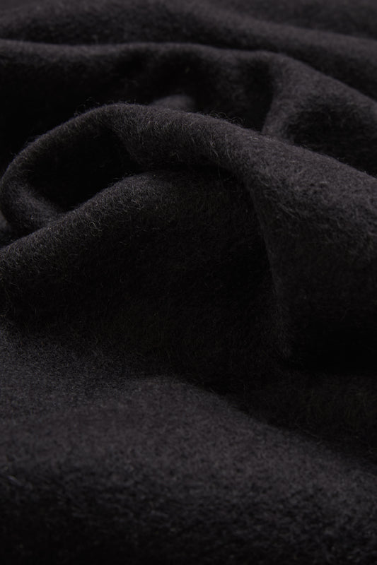 Women's accessories cashmere scarf, black, soft pure cashmere fabric with subtle folds.