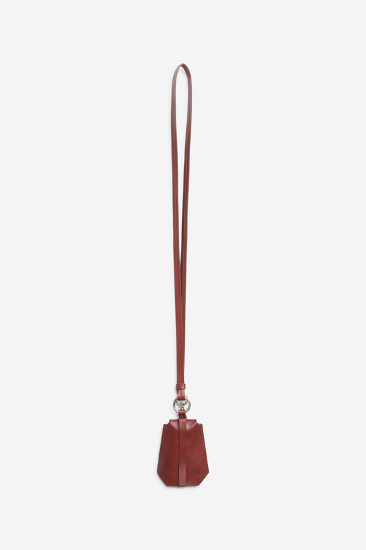 Unisex accessories key chain, vegetable-tanned leather, brown, with long strap and tracker compartment.