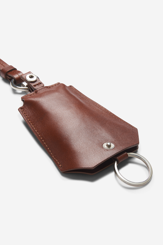 Unisex accessories key chain, vegetable-tanned leather, brown, with silver key ring and snap closure.