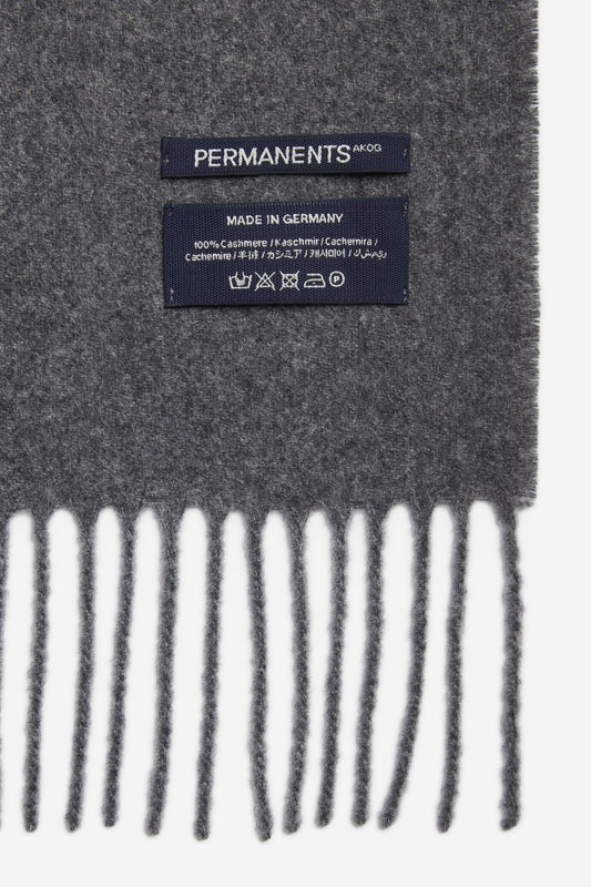 Unisex accessories scarf 100% cashmere grey melange with fringe and "PERMANENTS" label.
