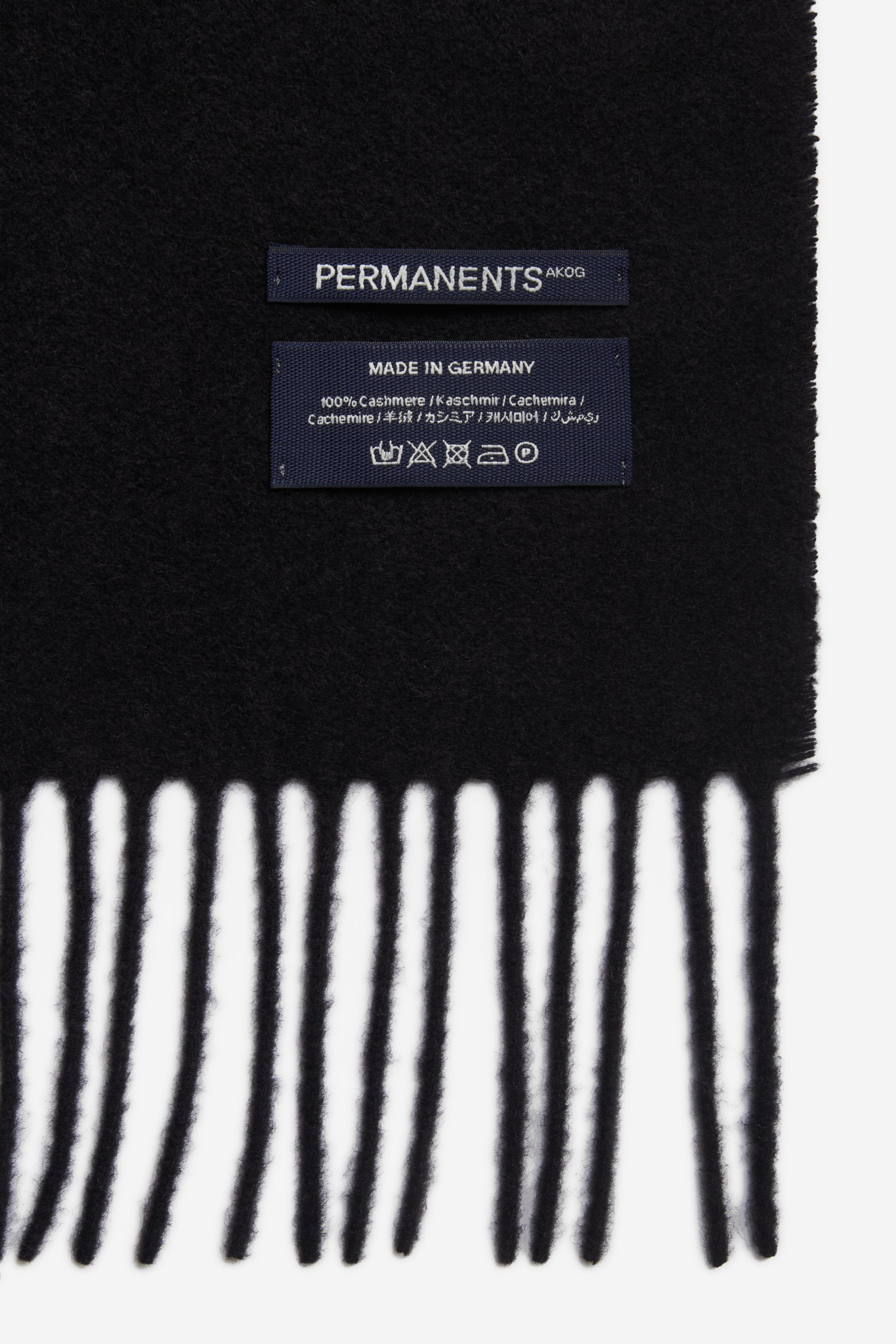 Unisex accessories scarf, 100% cashmere, black, with fringe and "PERMANENTS" label.