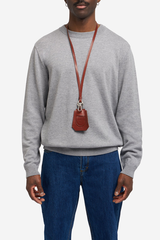 Men's accessories, key chain, vegetable-tanned leather, brown, worn around neck, with silver hardware.