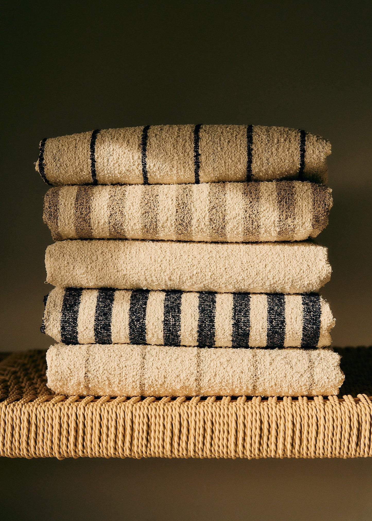 Stack of five linen-cotton blend towels with wide indigo stripes and natural cooling effect.
