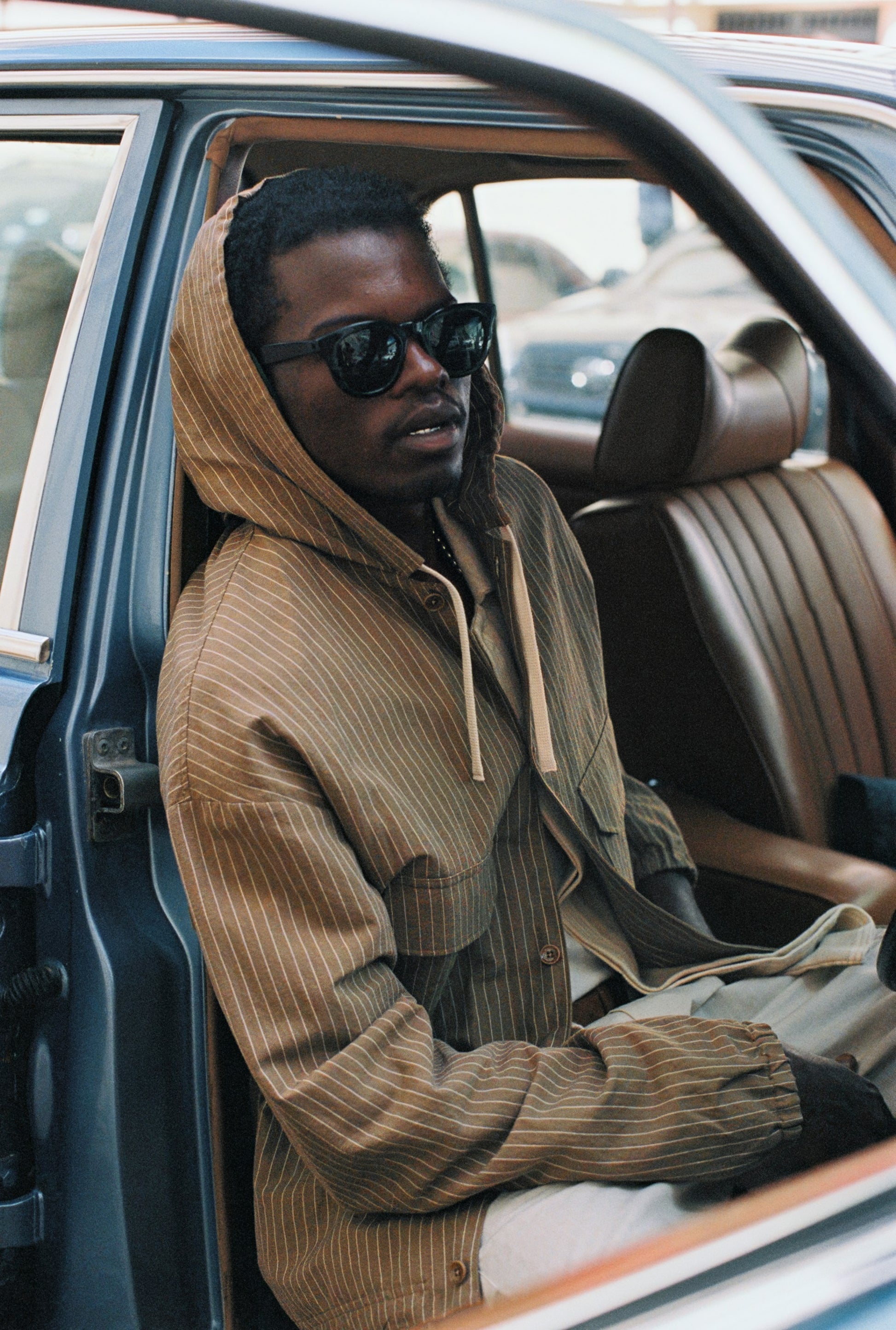Men's outerwear jacket, cotton-linen seersucker with fine pinstripes, light brown, hooded, adjustable hem.