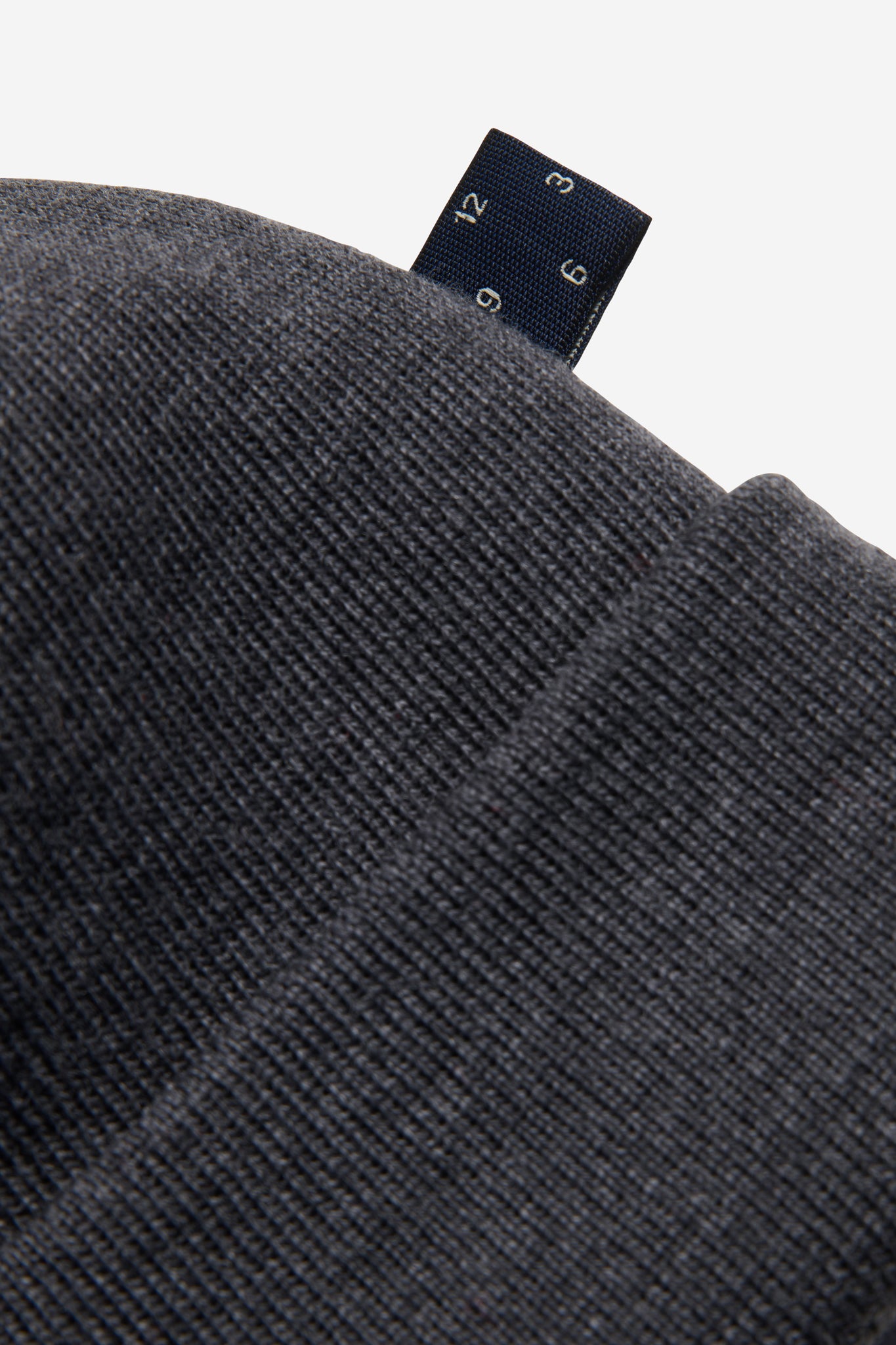 Unisex accessories beanie, 100% merino wool, dark grey, with a small blue brand tag.