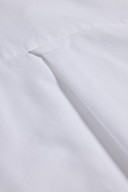 Unisex long-sleeved shirt, white organic cotton, with a visible pocket detail.