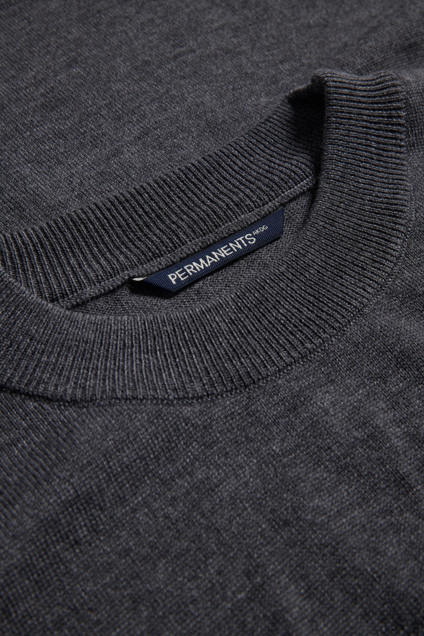 Unisex knit crewneck, dark-grey mulesing-free merino wool, with rib-knit neck, cuffs, and hem.