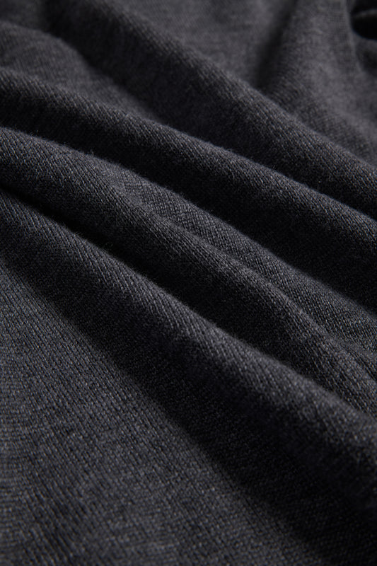 Unisex knit crewneck, dark-grey mulesing-free merino wool, finely knitted with visible rib-knit texture.