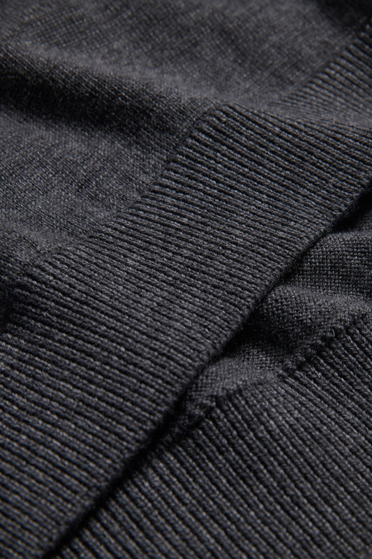 Unisex knit crewneck, dark-grey mulesing-free merino wool, showing rib-knit texture on cuffs and hem.