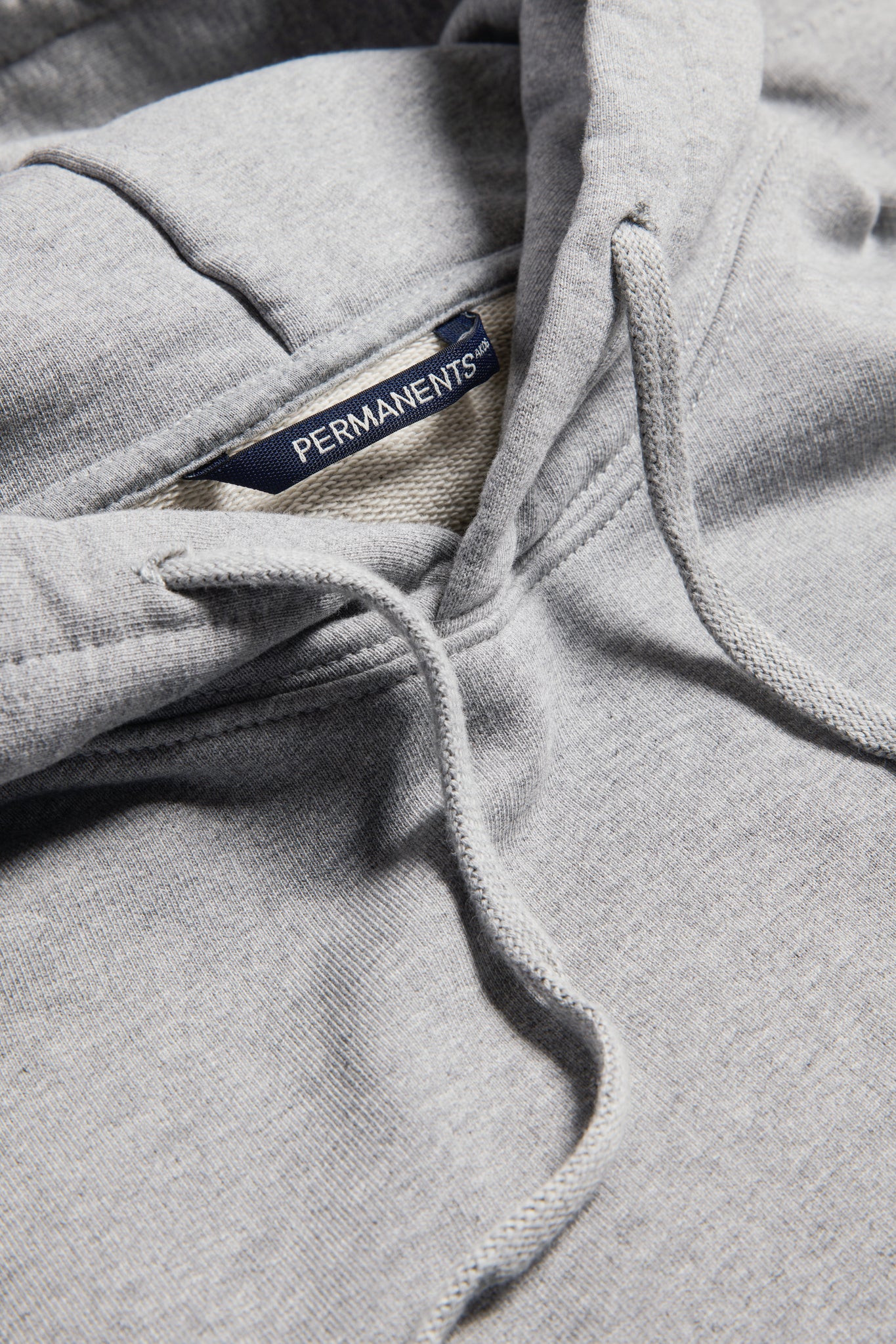 Unisex jersey hoodie, organic cotton, pre-washed, grey melange, with PERMANENTS® label.
