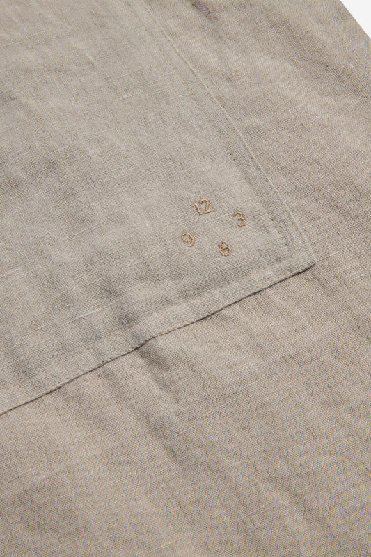 Unisex accessories apron, 100% Belgian linen, flax, with embroidered clock numbers on a patch pocket.