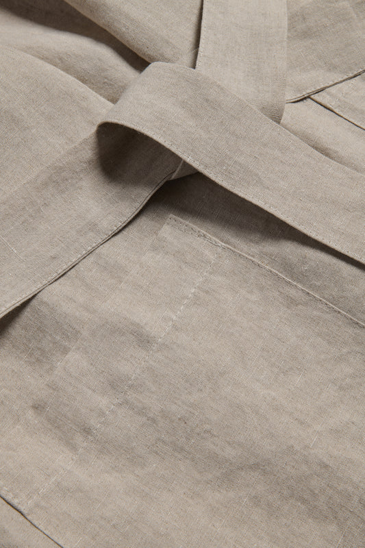 Unisex bathrobe, 100% Belgian linen, flax color, with a tied belt and patch pocket detail.