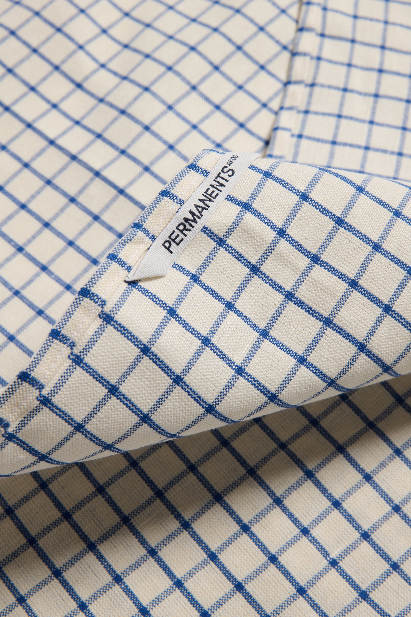 Accessories tea towel, linen-cotton blend, indigo check pattern, with "PERMANENTS" label.