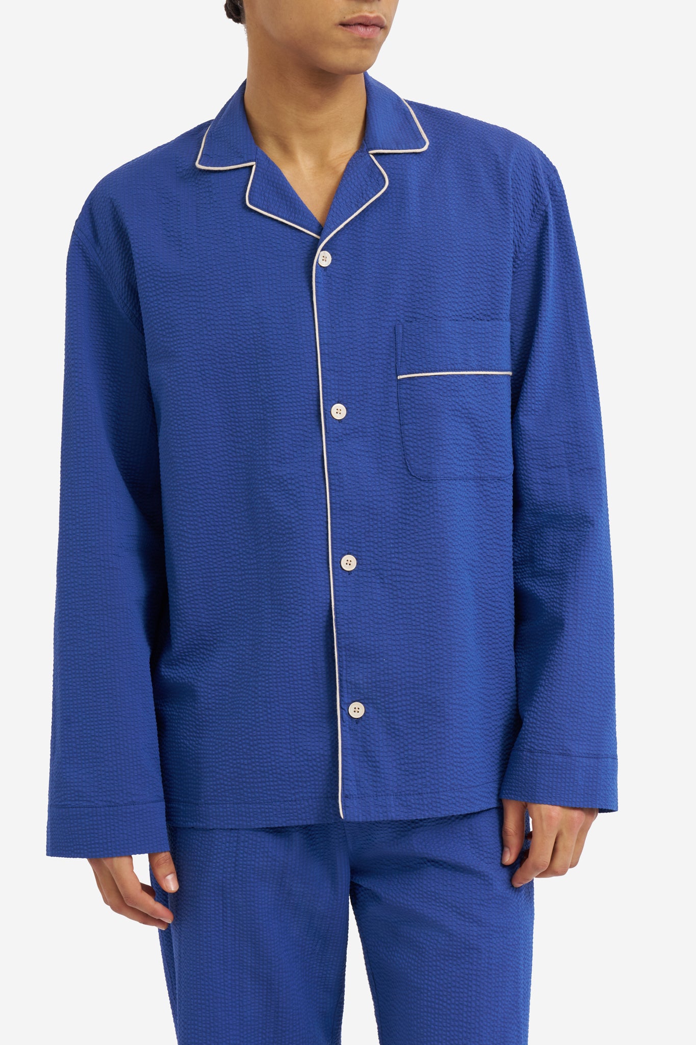 Men's long-sleeved shirt and long-pants pyjama set, organic cotton seersucker, blue hour, with white piped trim.