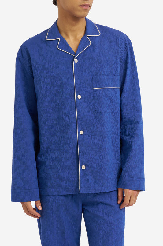 Men's long-sleeved shirt and long-pants pyjama set, organic cotton seersucker, blue hour, with white piped trim.