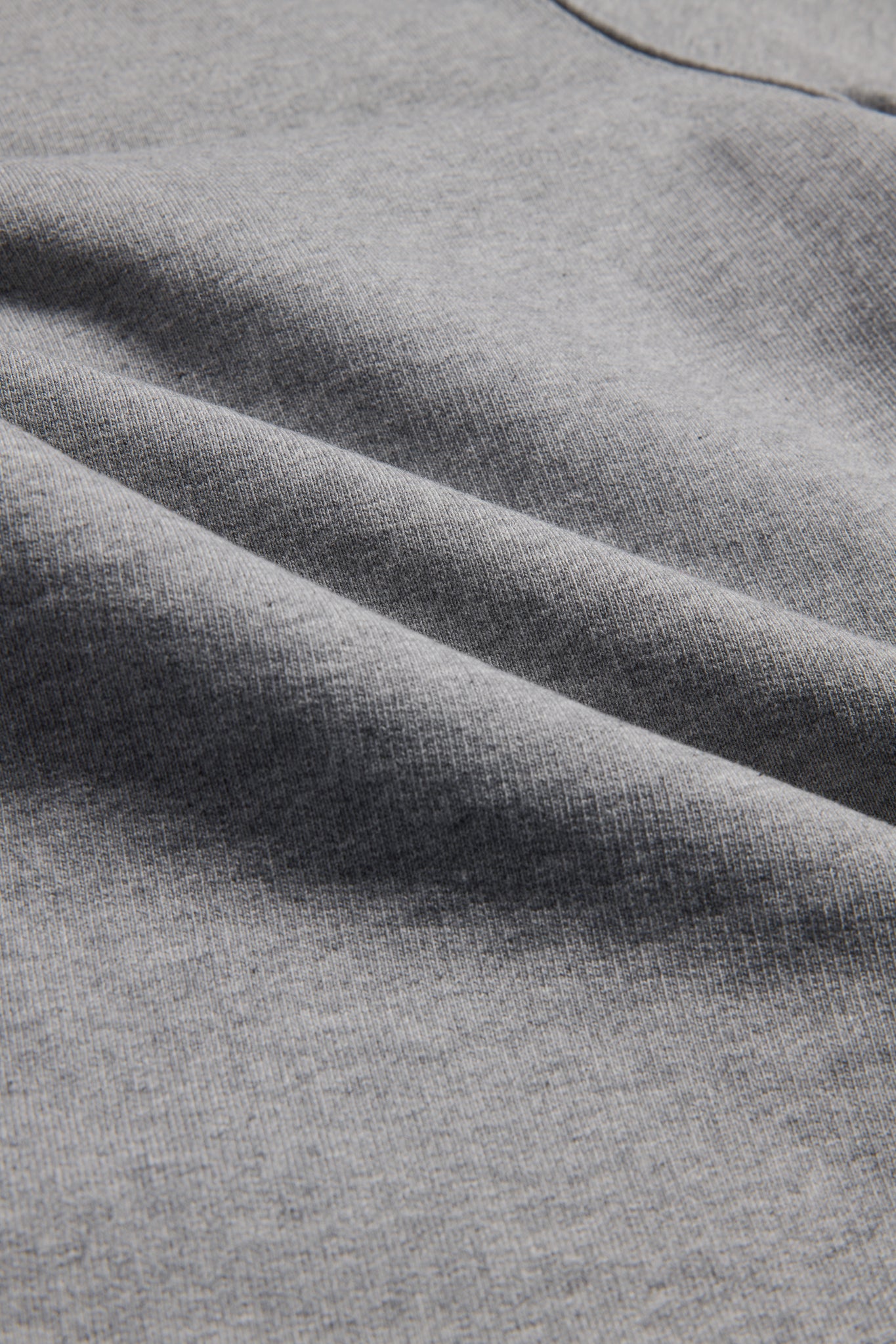 Unisex long-pants, heavy jersey organic cotton, grey melange, with subtle fabric folds.