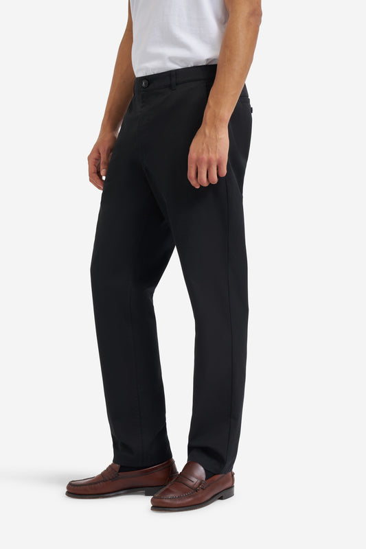 Men's long pants, organic cotton twill, washed black, flat front, tapered fit, side and button-up back pockets.