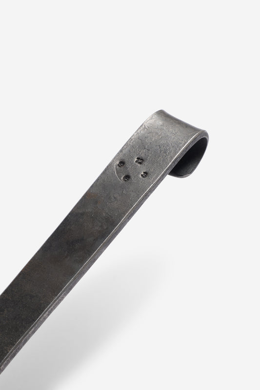 Dark grey wrought iron pan handle with embossed logo, handmade in Bavaria.