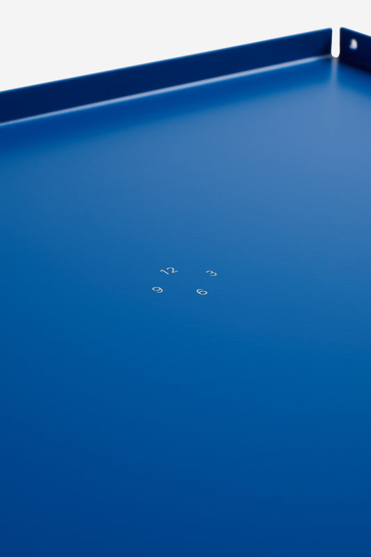 Accessories tray, single piece gentian coated aluminum, 34x26cm, with subtle white numbers.