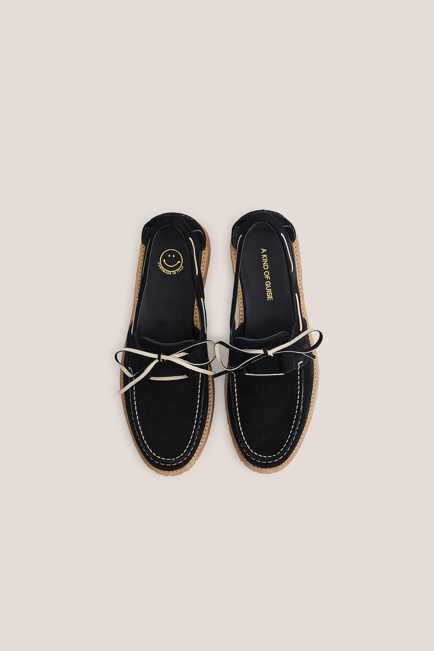 Women's accessories boat sandal, black Italian vegetal cowhide, white lacing, and natural sole.
