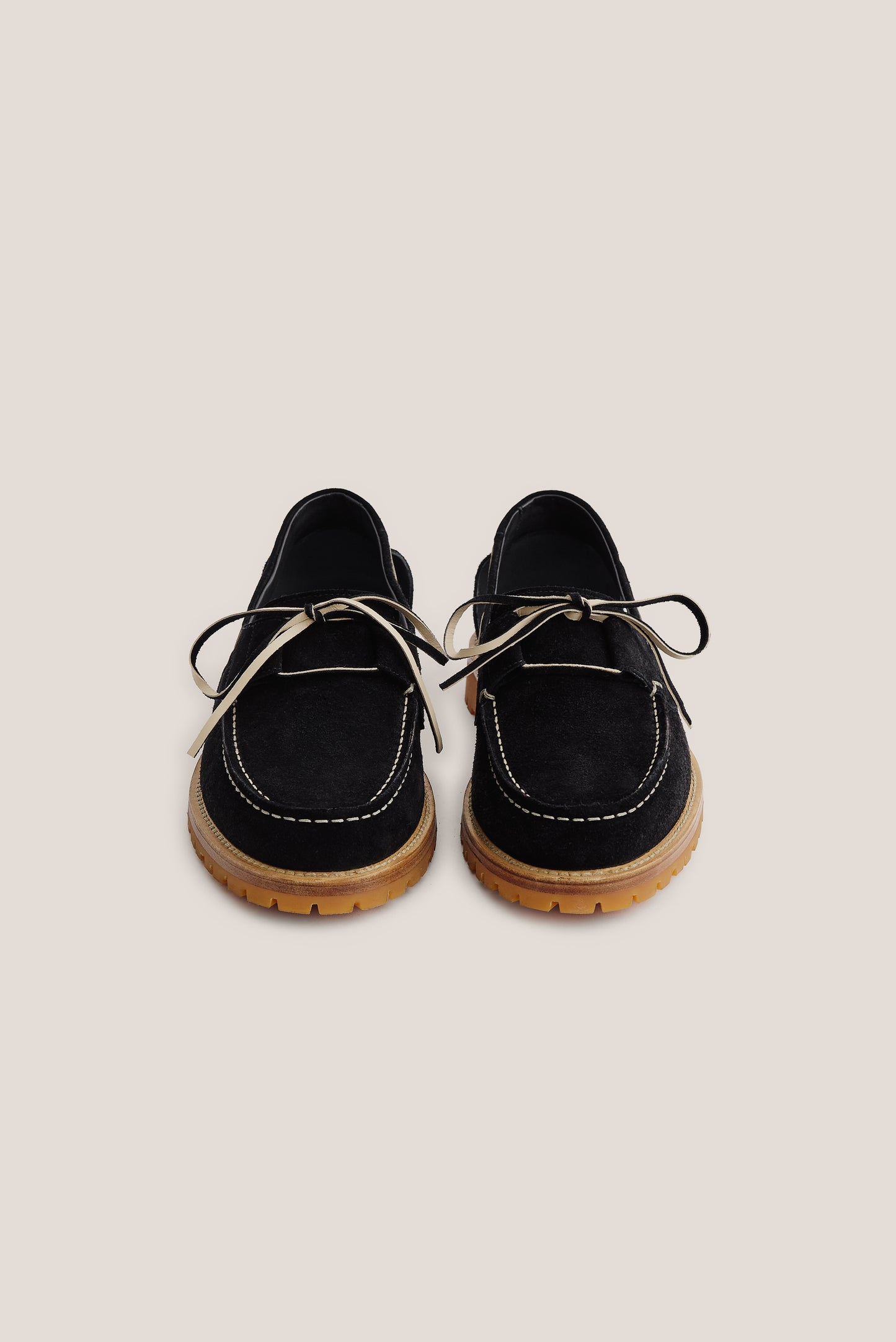 Women's accessories boat sandal, black Italian vegetal cowhide, with white stitching and tan lug sole.