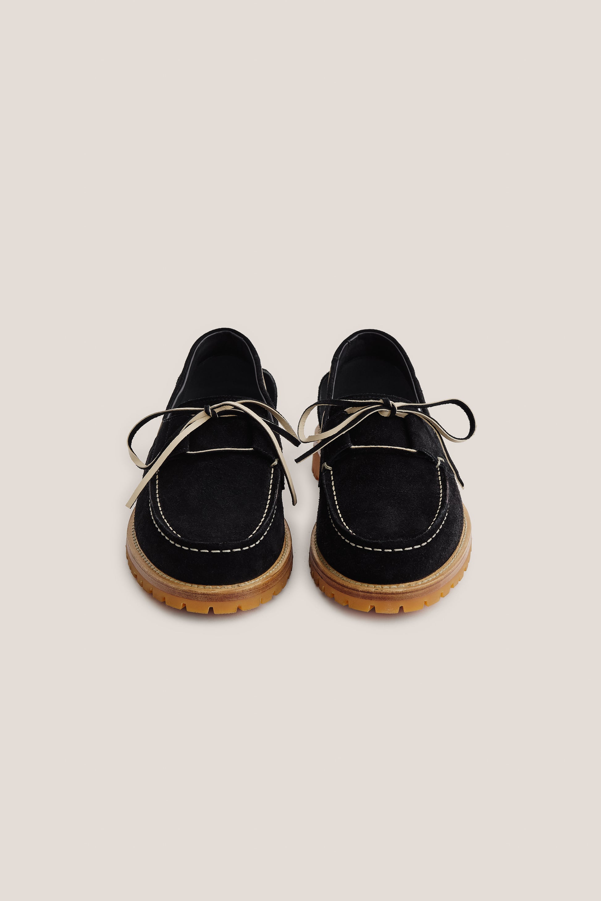 Women's accessories boat sandal, black Italian vegetal cowhide, with white stitching and tan lug sole.