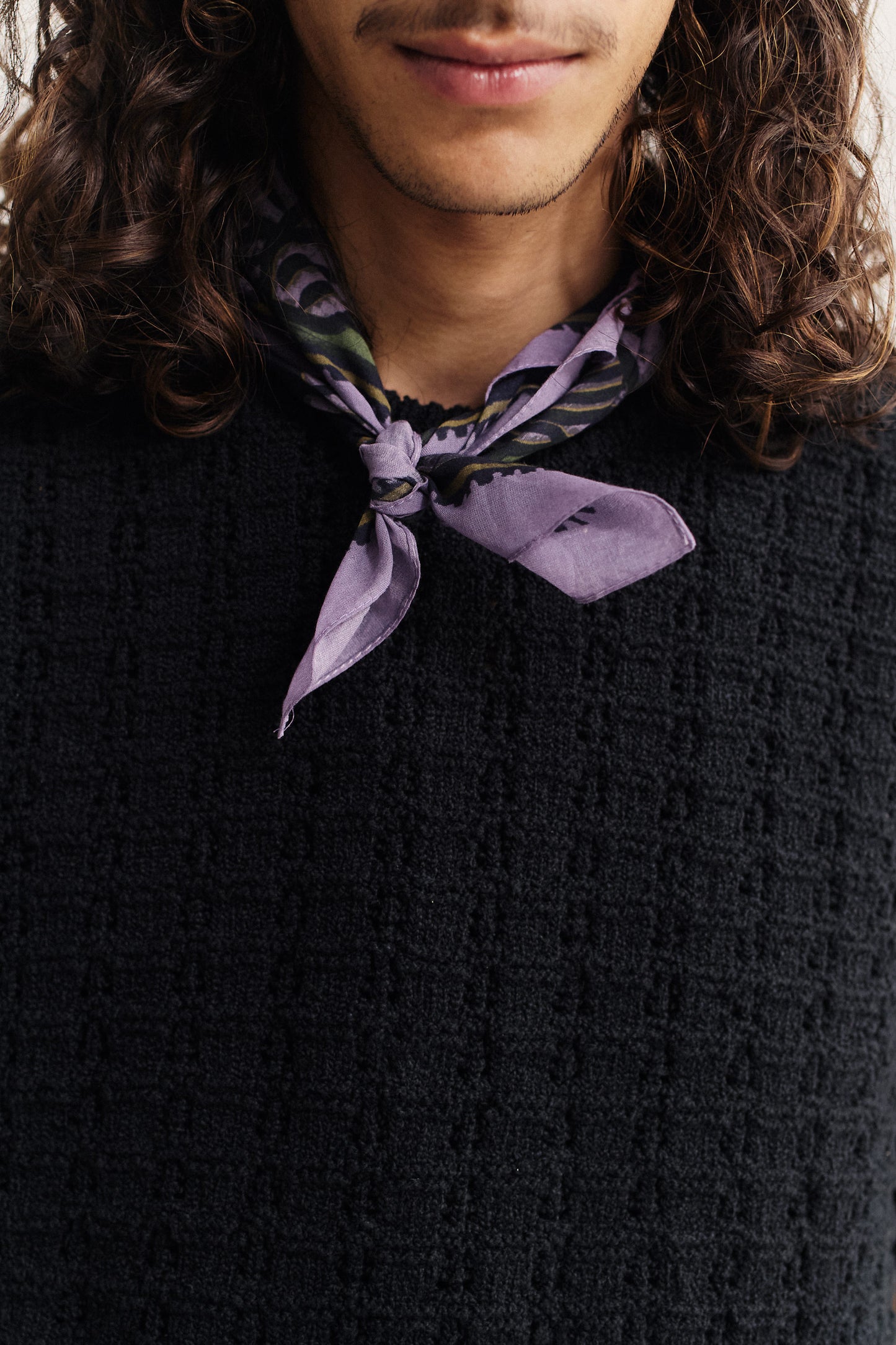 Men's accessories cotton bandana, purple with African wildlife print, tied around the neck.