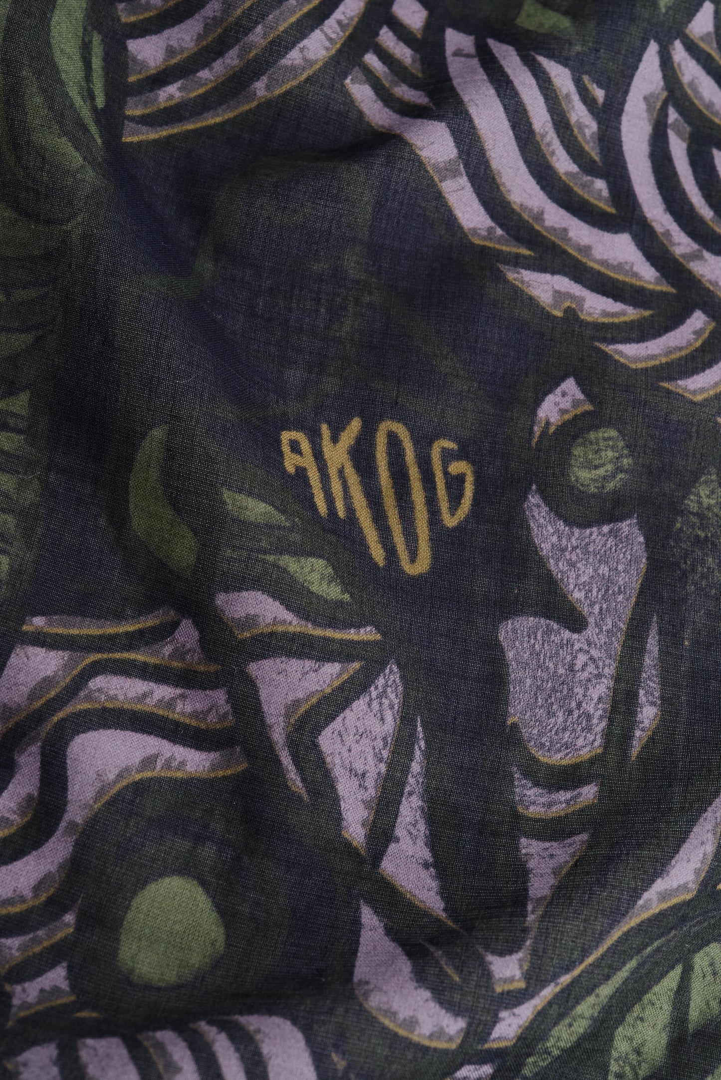 Unisex accessories bandana, 100% cotton, dark green with African wildlife print and "AKOG" logo.