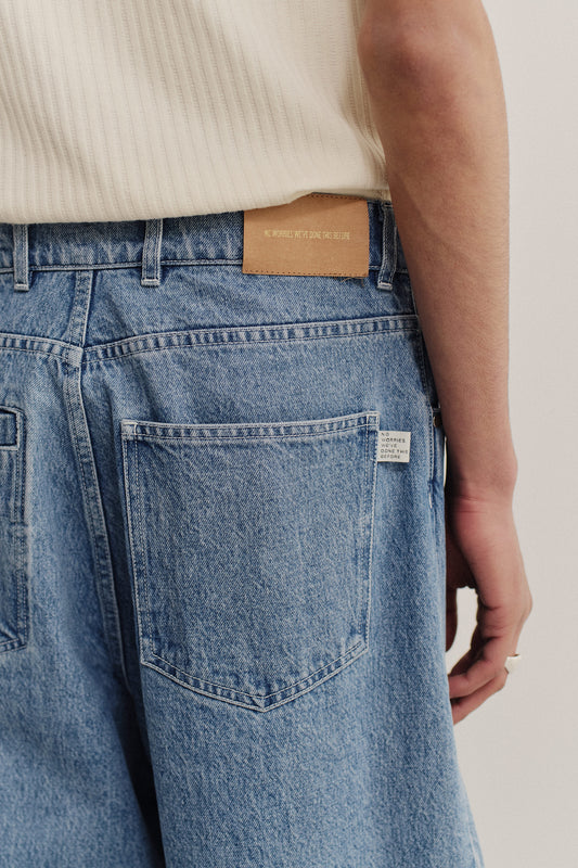 Men's long-pants, Duma Pleated Denim, recycled cotton mix, stone washed, light blue, with classic 5-pocket design.