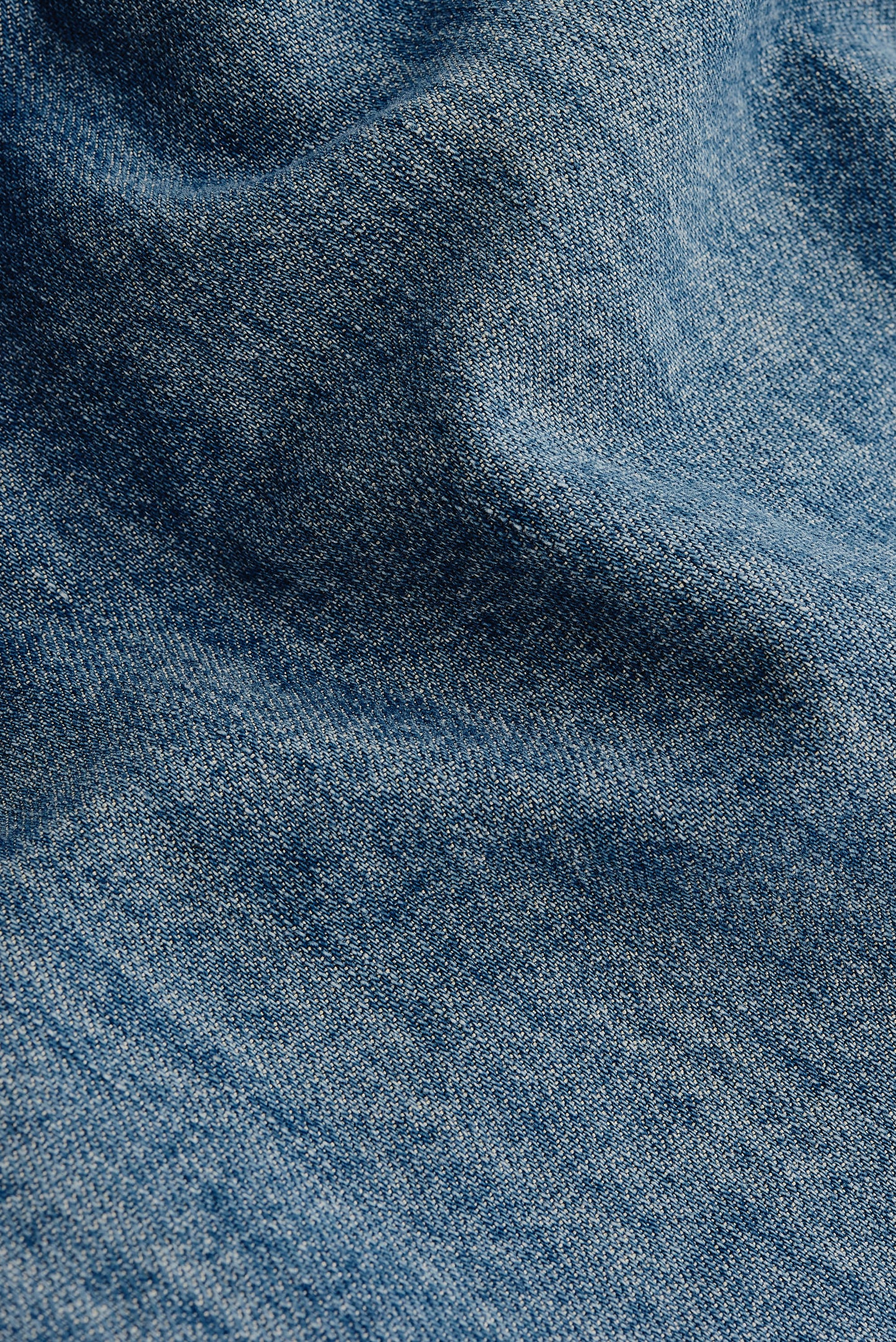 Men's long-sleeved shirt, light blue organic cotton, viscose, and silk denim fabric with vintage-inspired texture.